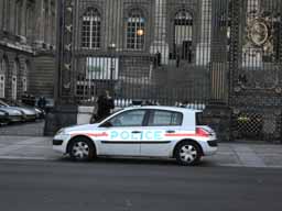Colorful and reflective police car Cute little police car outside the ornate gates of Palais de Justice. © 2005 Lykara I. Charters
