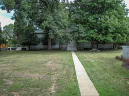 The sidewalk represents the Zero Meridian for the United States. The building in the background used to hold chronometers. Until 1883, official US time and navigation were determined from this starting spot. Photo © Lawrence I. Charters